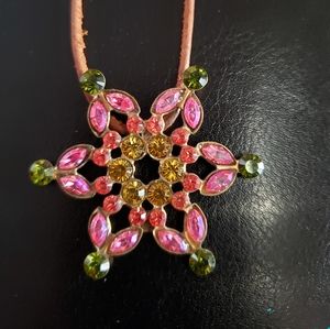 Sorrelli flower pendant on brown cord